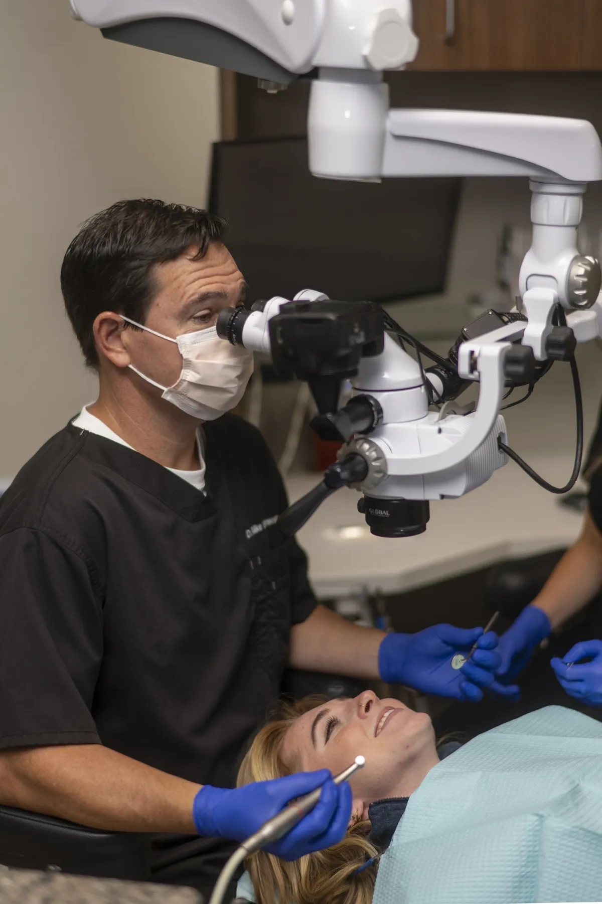Insurance A dentist is looking into the eye of a patient.